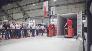 D12 HP elektromos raklapemelő és T20 alacsony emelésű raklapszállító működésben az árubeérkezésnél a WoMH 2022 kiállításon. D12 HP elektromos raklapemelő és T20 alacsony emelésű raklapszállító működésben az árubeérkezésnél a WoMH 2022 kiállításon.